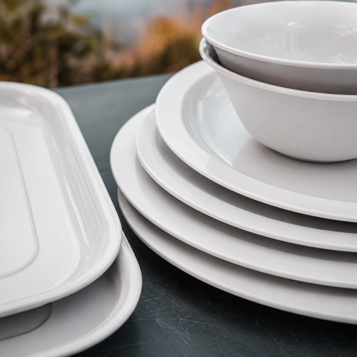 Close-up of the stacked white polycarbonate plates and bowls