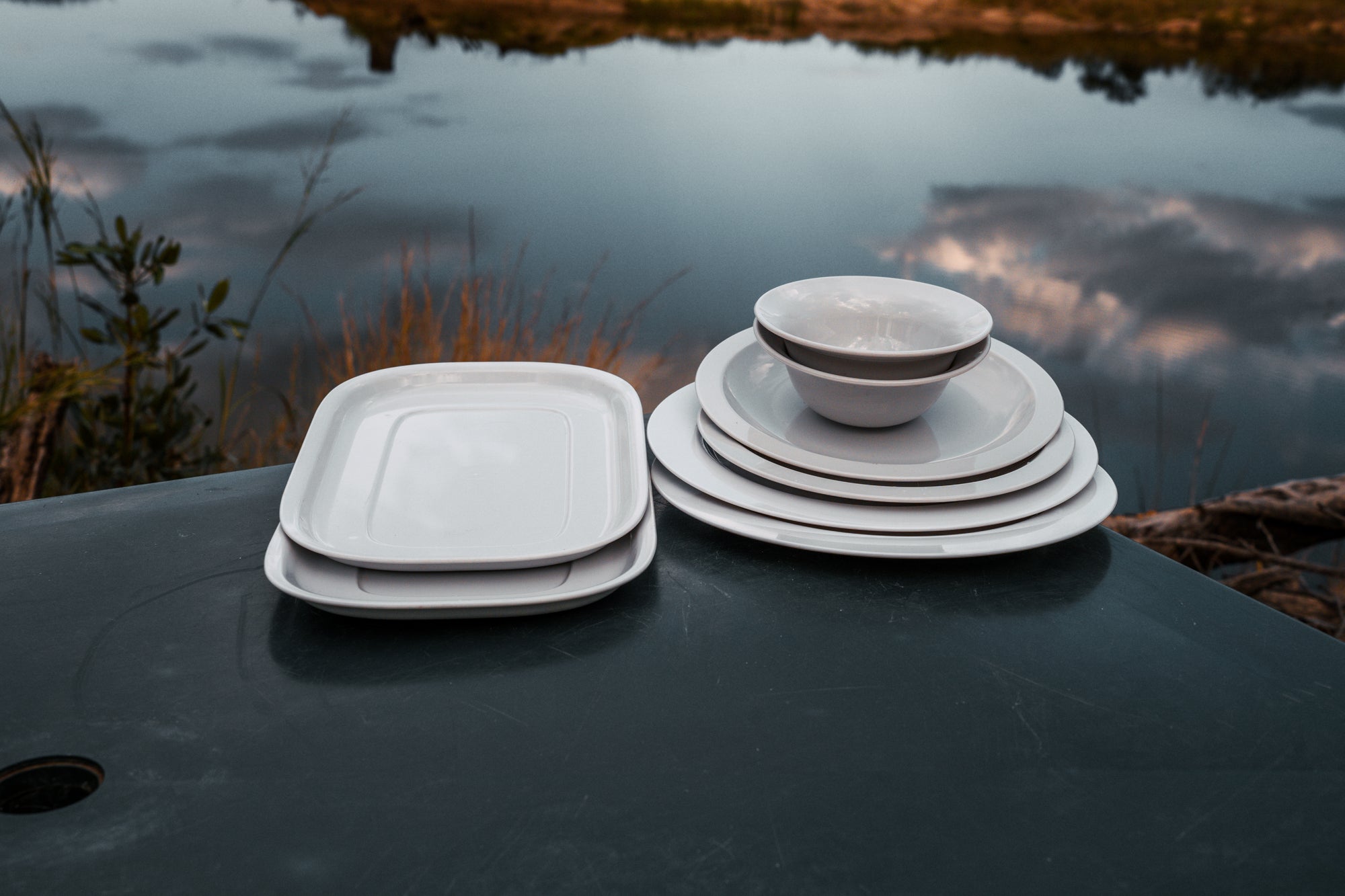 Camp dinner set laid out at an outdoor braai